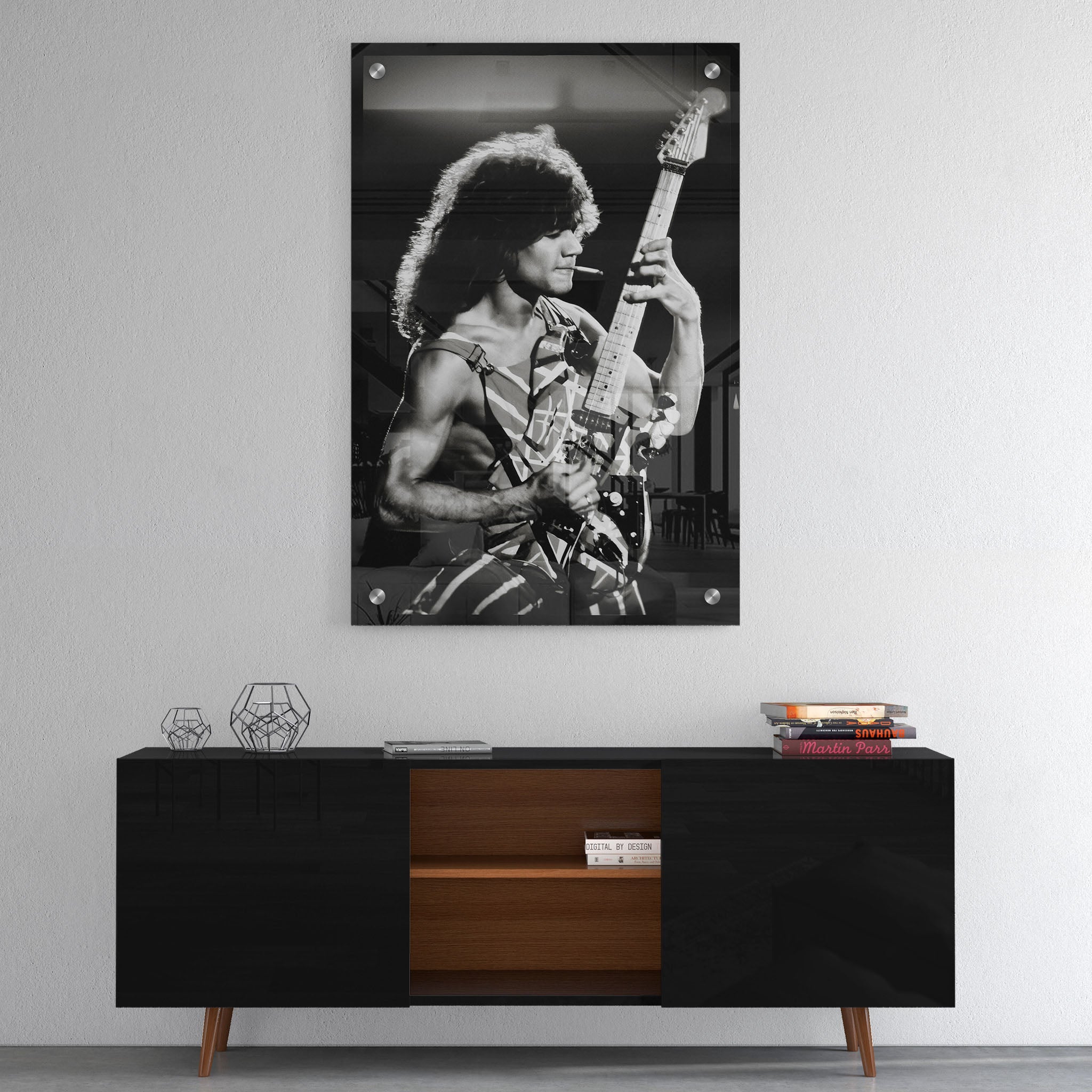 High-gloss acrylic glass black and white print of Eddie Van Halen displayed above a contemporary console.
