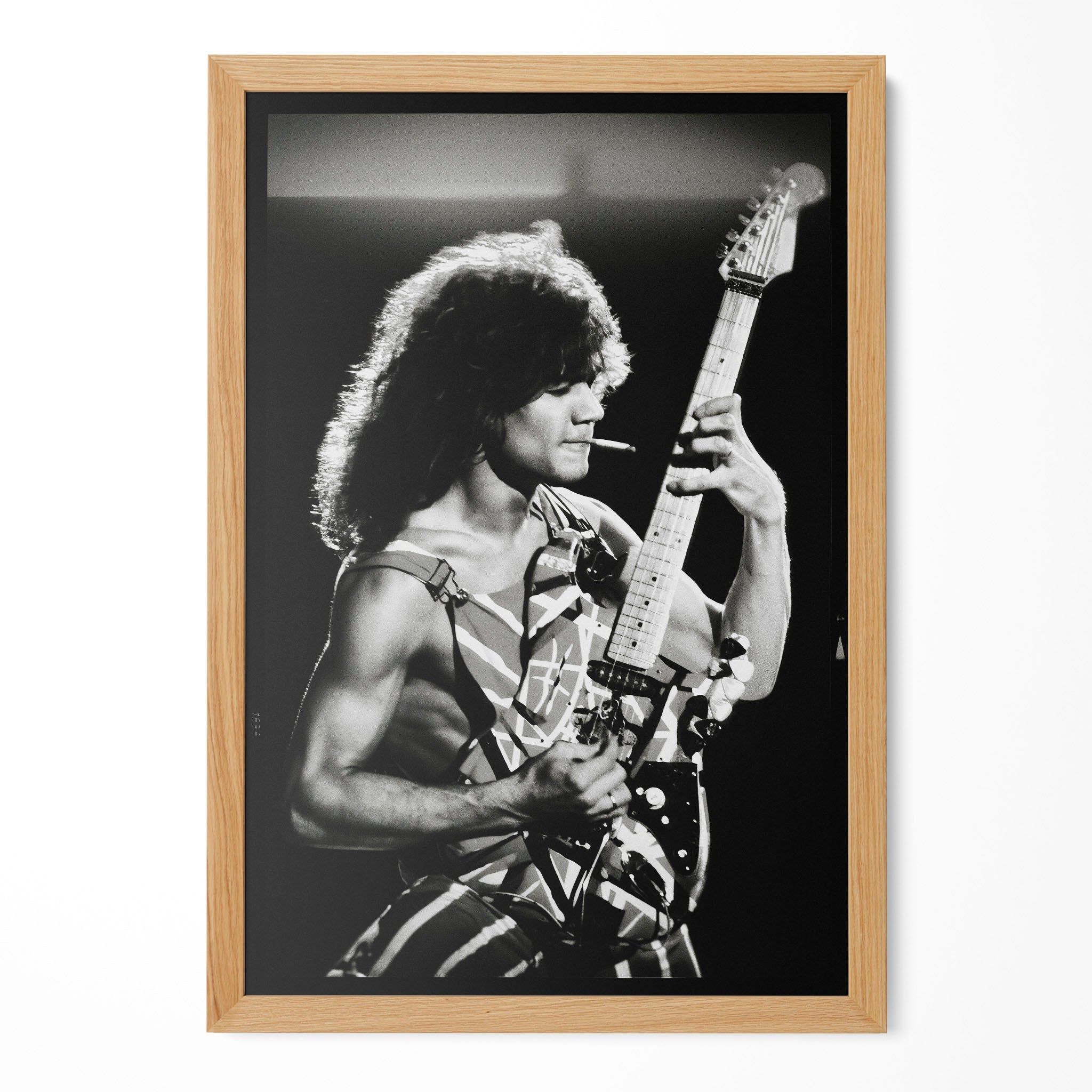 Eddie Van Halen 1982 black and white guitar poster in a premium natural oak wood frame by POSTEREVER.