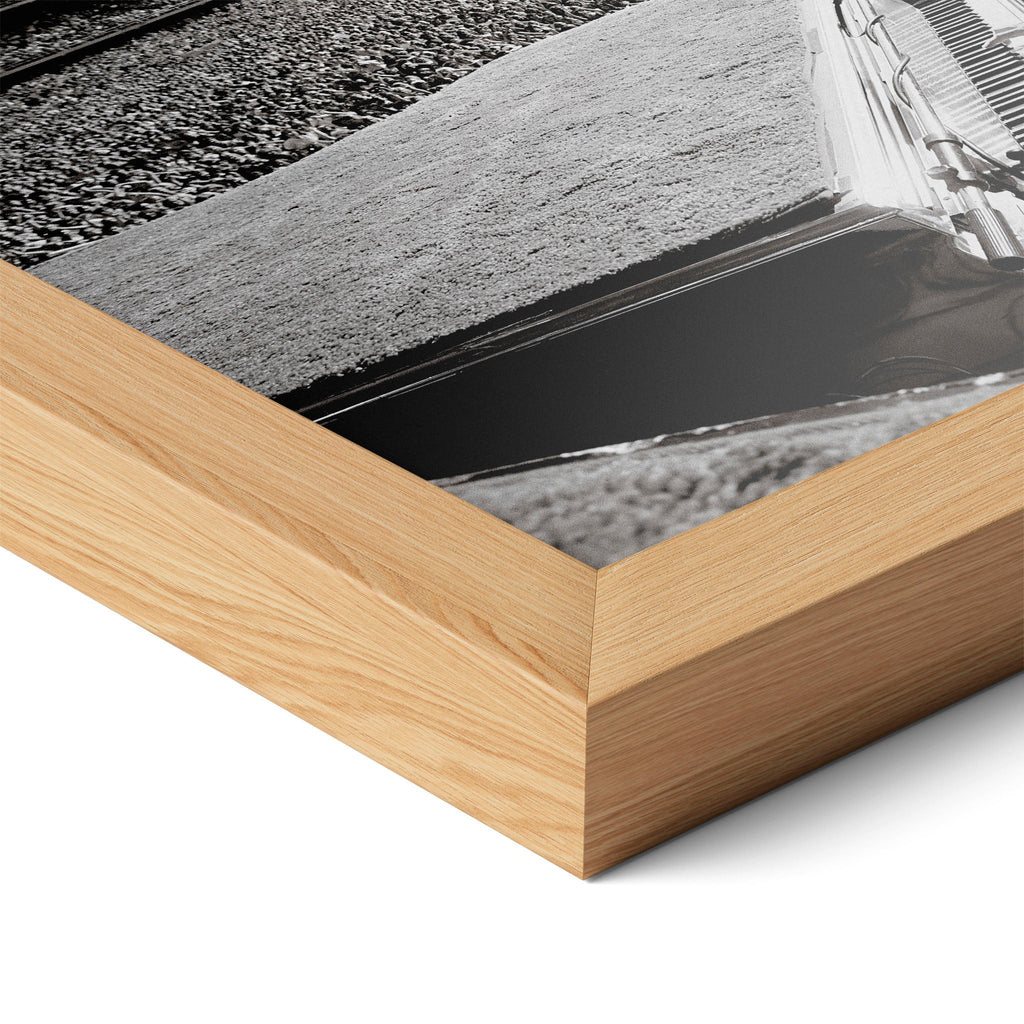 Corner close-up highlighting the natural oak finish of the framed Elton John 1975 black and white poster.