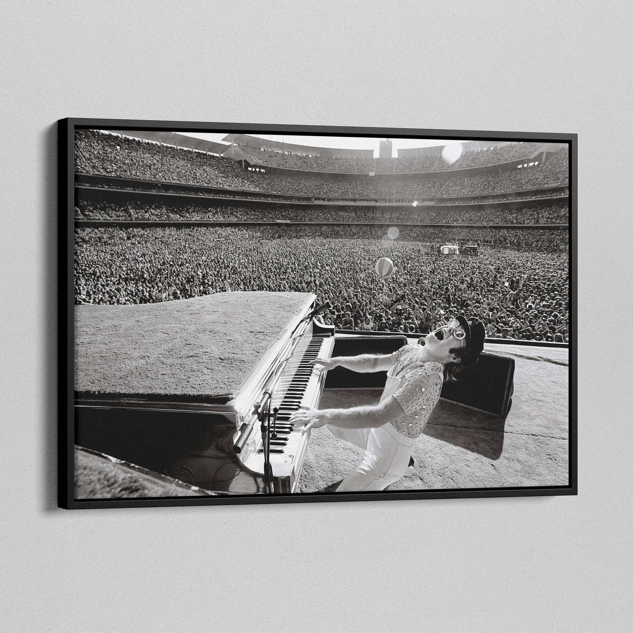 Side angle of the Elton John 1975 black and white canvas in a luxury minimalist black floating frame.