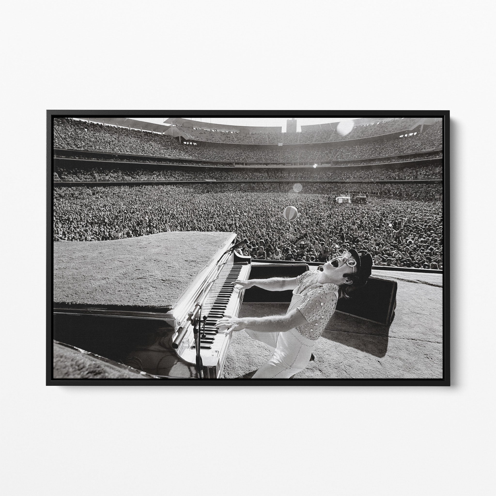 Front view of the Elton John 1975 black and white canvas in a sleek black floating frame.