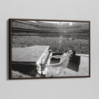 Angled view of the Elton John 1975 black and white canvas in a sophisticated dark walnut floating frame.
