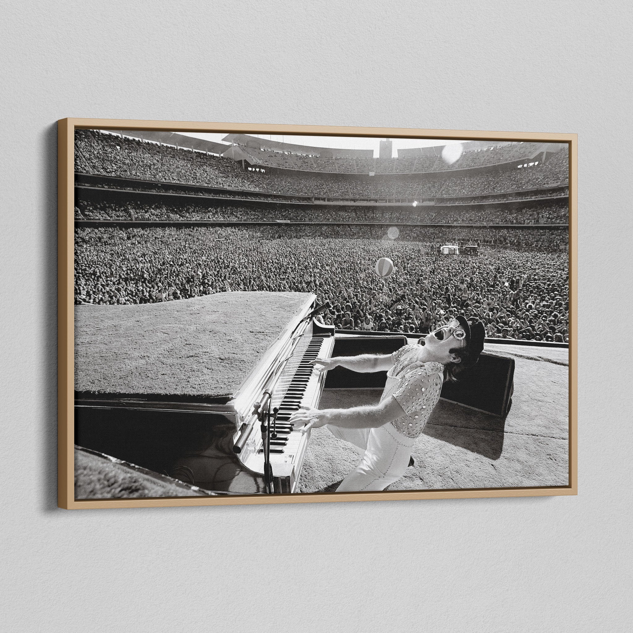 Angled view of the black and white canvas in a modern natural oak wood floating frame.