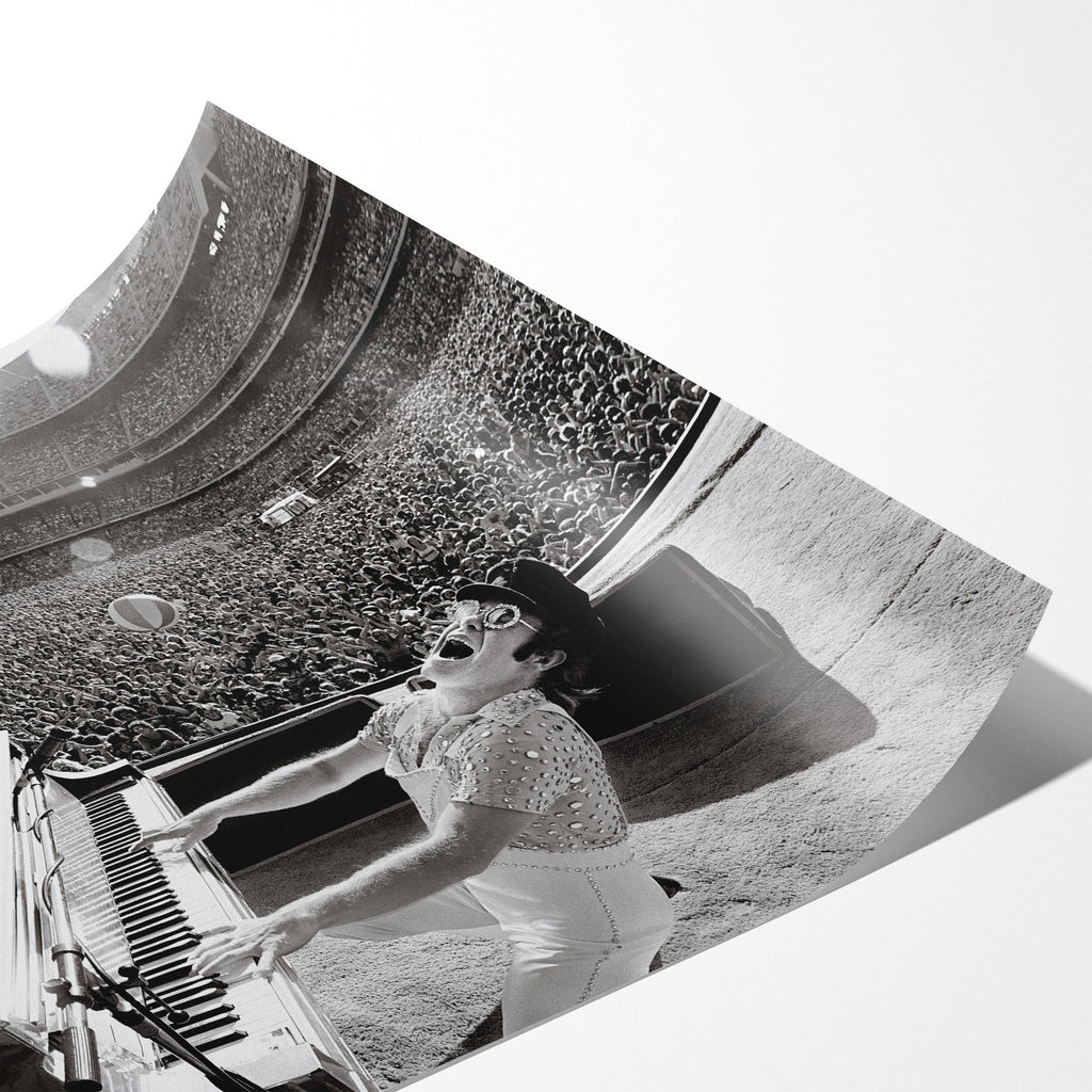 Angled close-up of the unframed premium matte black and white Elton John 1975 Dodger Stadium poster print.
