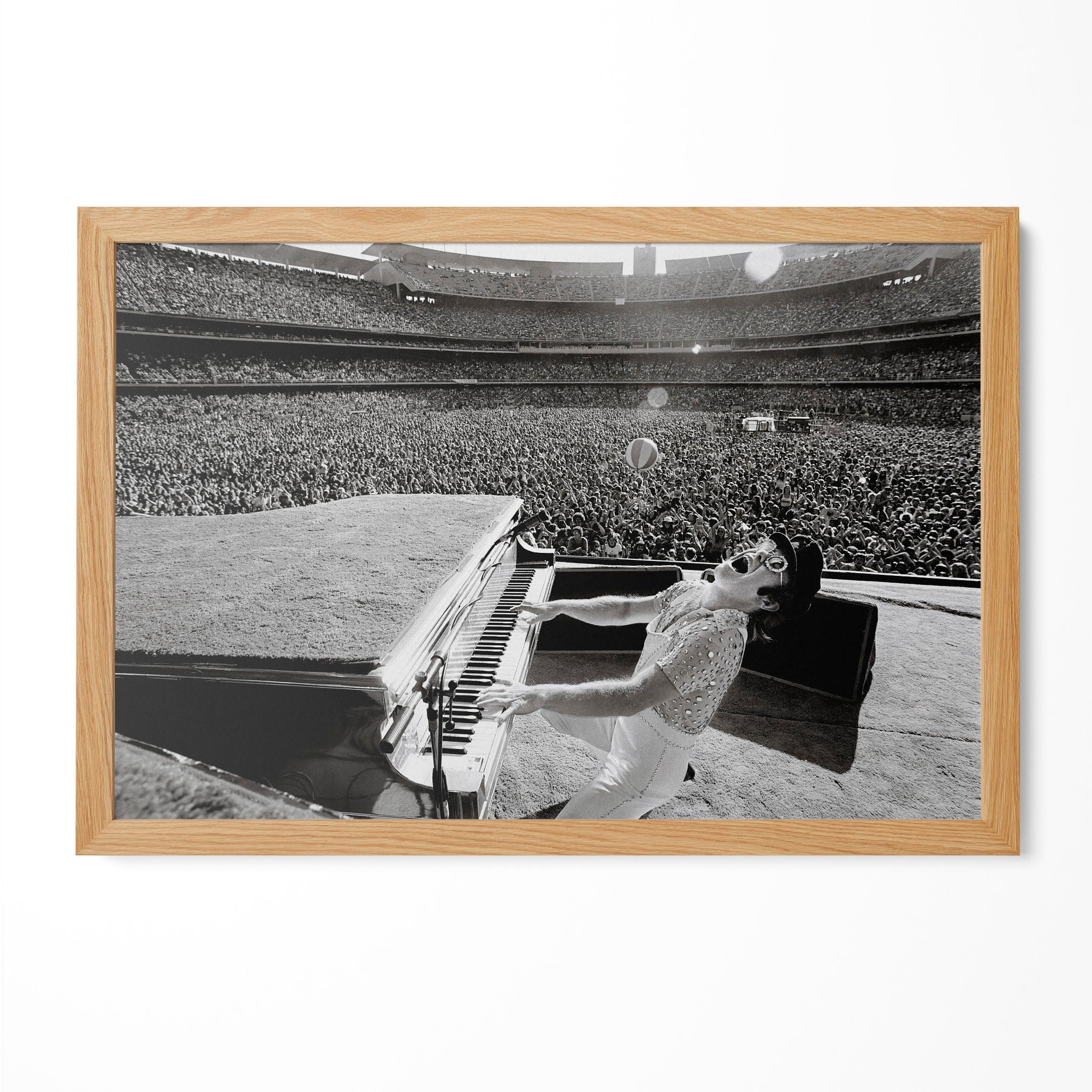 Elton John 1975 Dodger Stadium black and white poster in a premium natural oak wood frame by POSTEREVER.