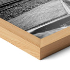 Corner close-up highlighting the natural oak finish of the framed Elton John 1975 black and white poster.