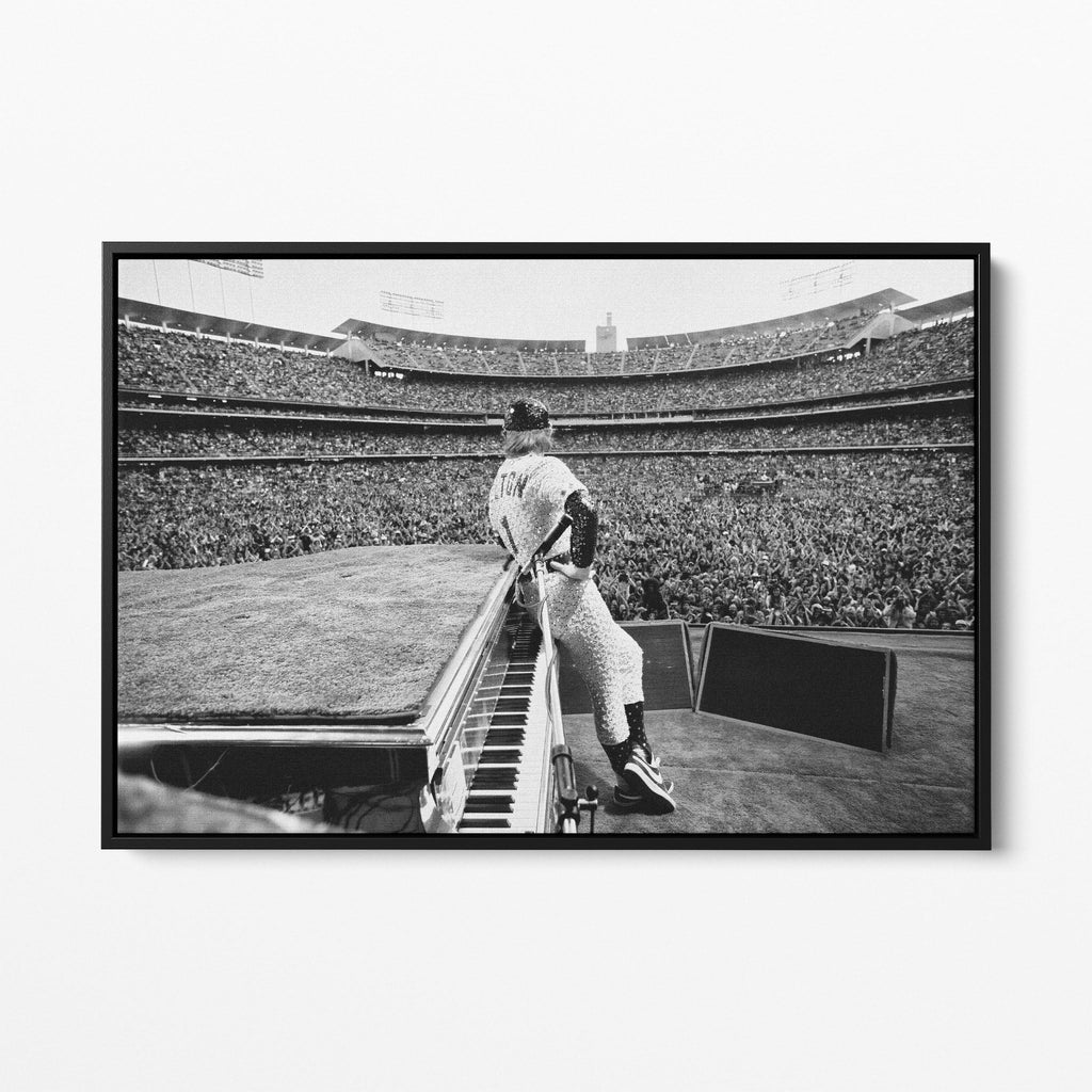 Front view of the Elton John 1975 black and white canvas in a sleek black floating frame.