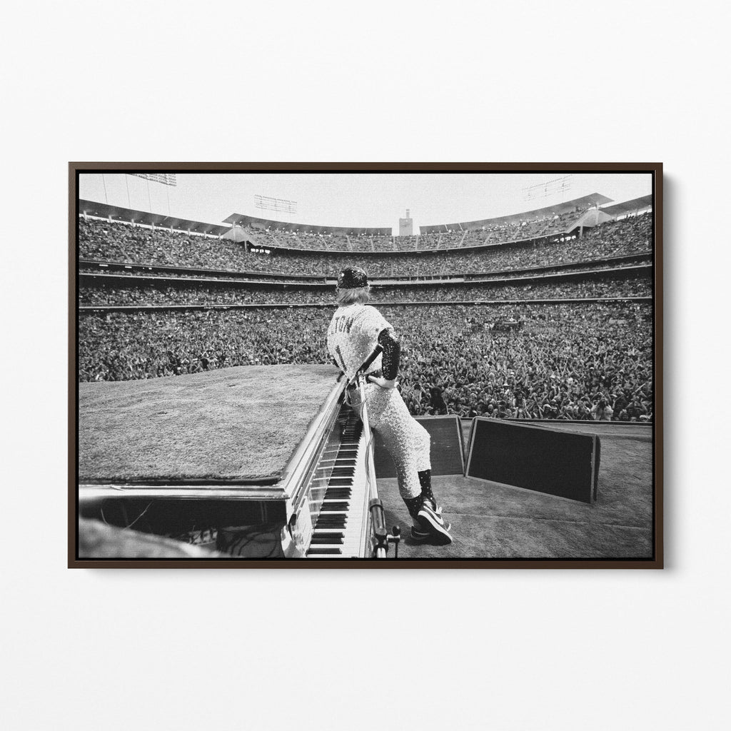 Front display of the Elton John 1975 black and white canvas in a premium dark walnut floating frame.
