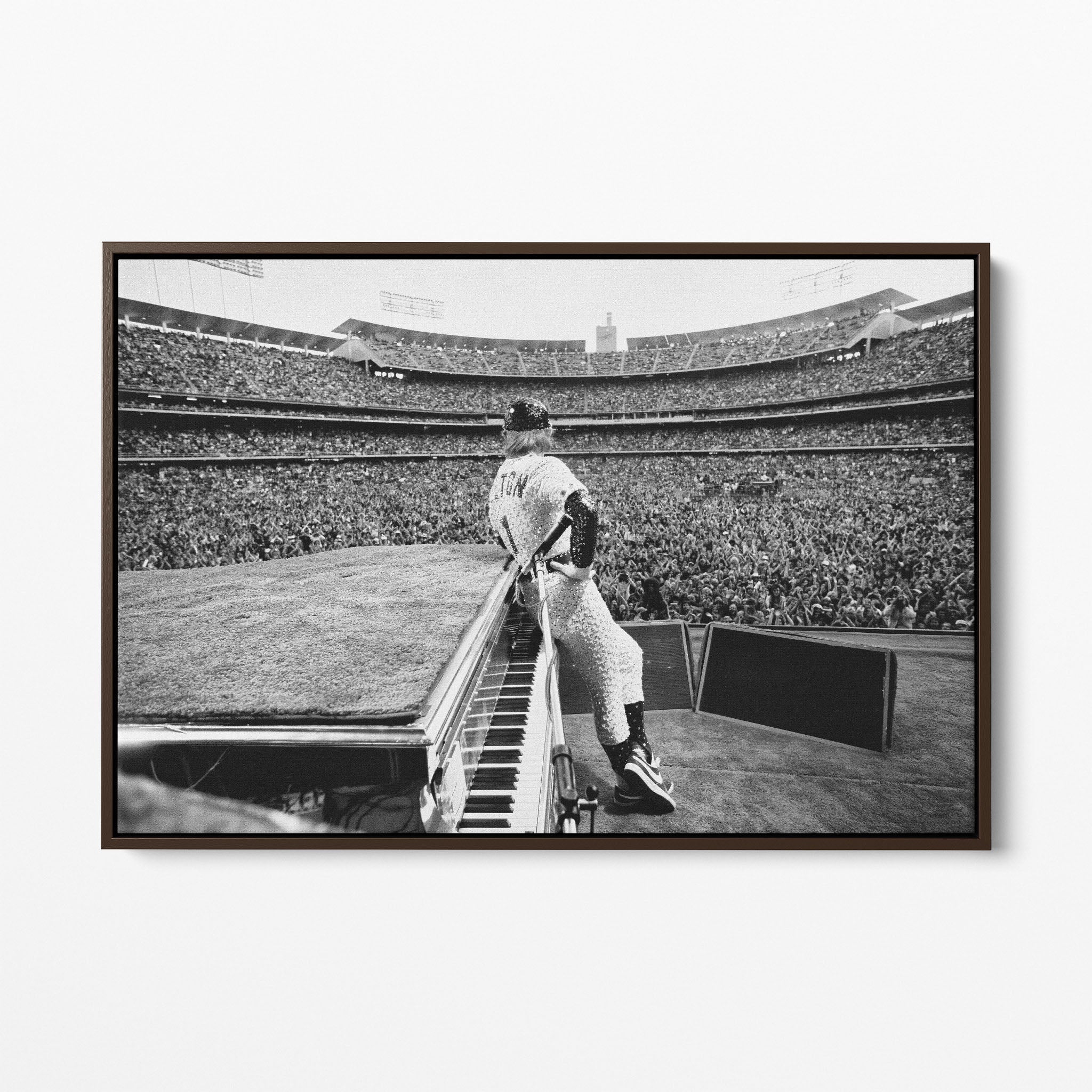 Front display of the Elton John 1975 black and white canvas in a premium dark walnut floating frame.