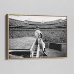 Angled view of the black and white canvas in a modern natural oak wood floating frame.