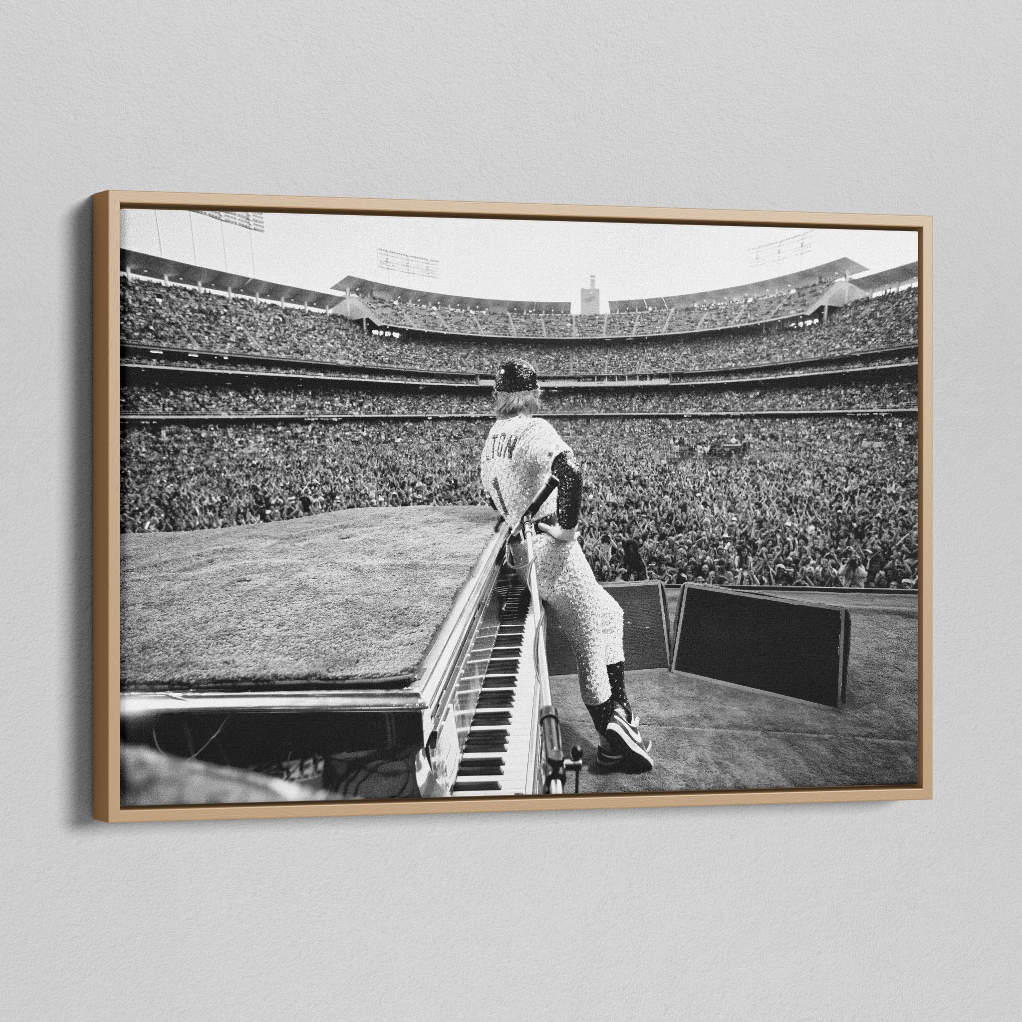 Angled view of the black and white canvas in a modern natural oak wood floating frame.