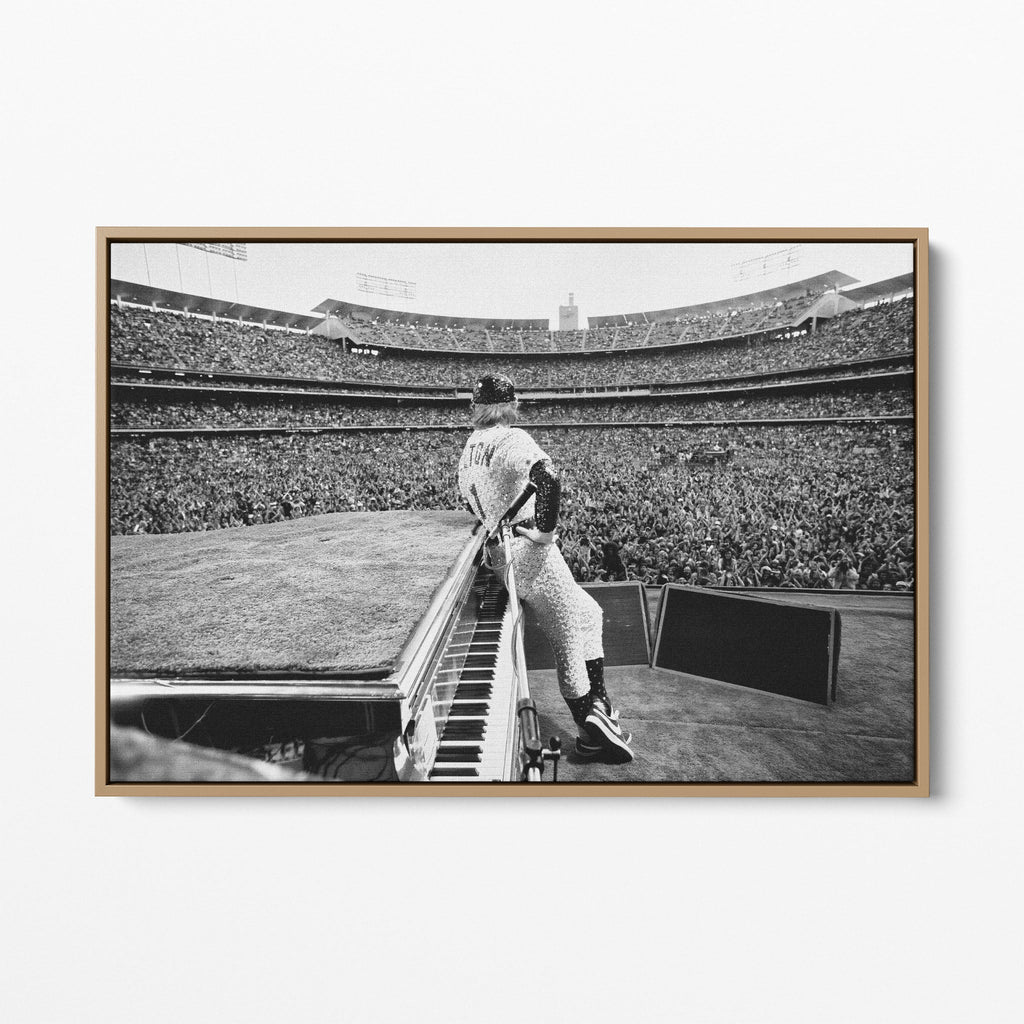 Front display of the Elton John 1975 black and white canvas in a premium natural wood floating frame.