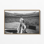 Front display of the Elton John 1975 black and white canvas in a premium natural wood floating frame.