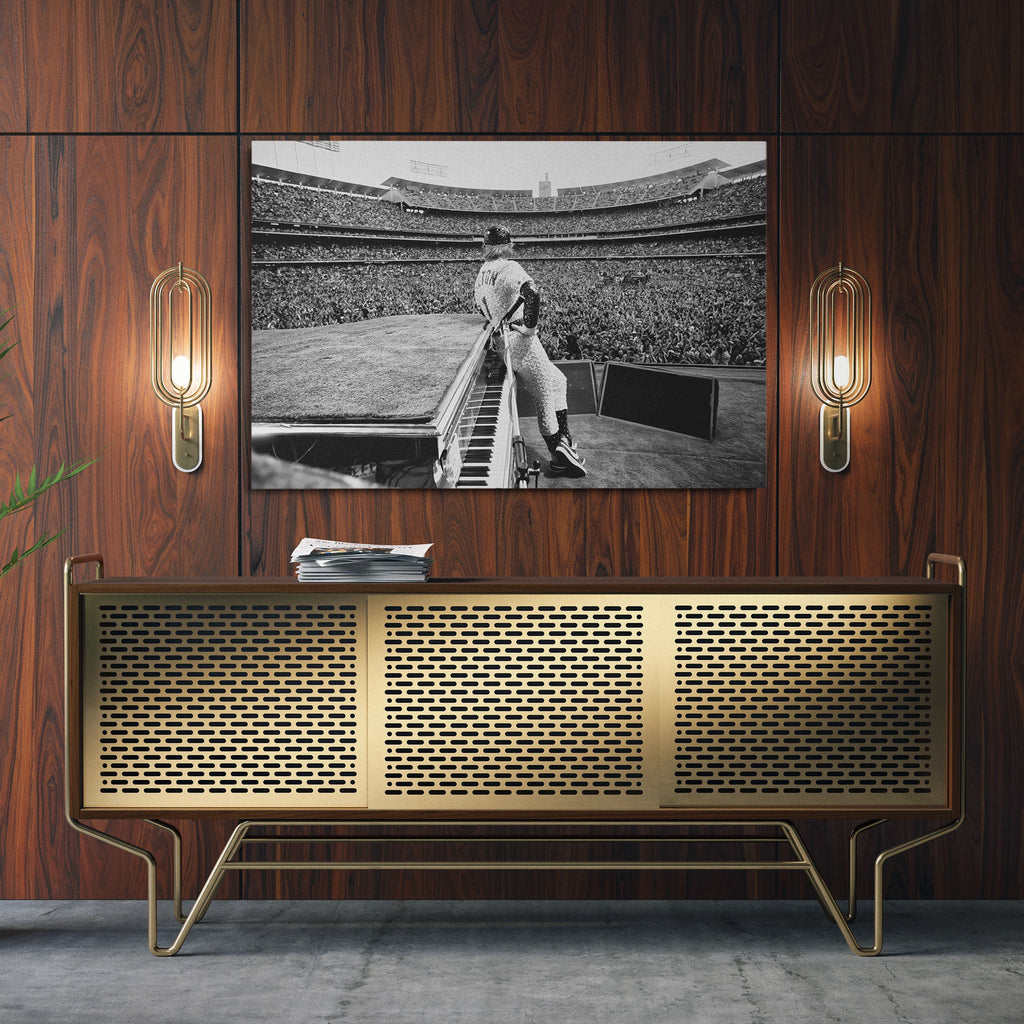 Sleek aluminum black and white metal print of Elton John displayed over a mid-century modern credenza.