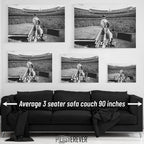 Elton John 1975 Dodger Stadium black and white wall art size comparison chart shown above an average 90-inch three-seater sofa.