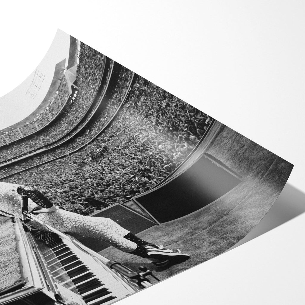 Angled close-up of the unframed premium matte black and white Elton John 1975 Dodger Stadium poster print.