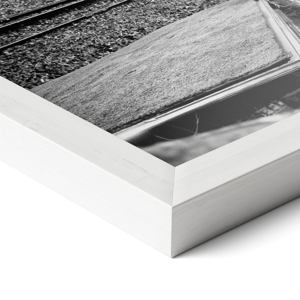 Corner close-up revealing the clean wood grain of the white framed Elton John 1975 black and white art print.