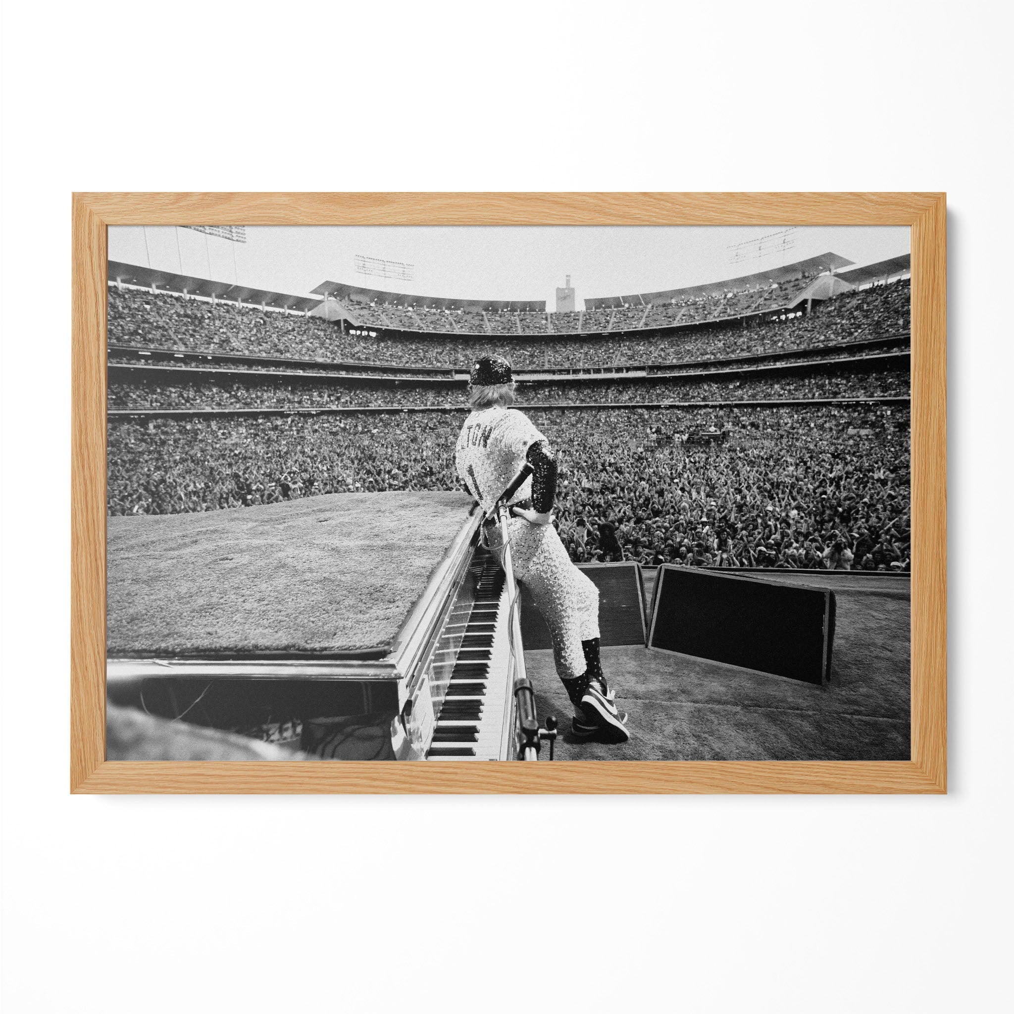 Elton John 1975 Dodger Stadium black and white poster in a premium natural oak wood frame by POSTEREVER.