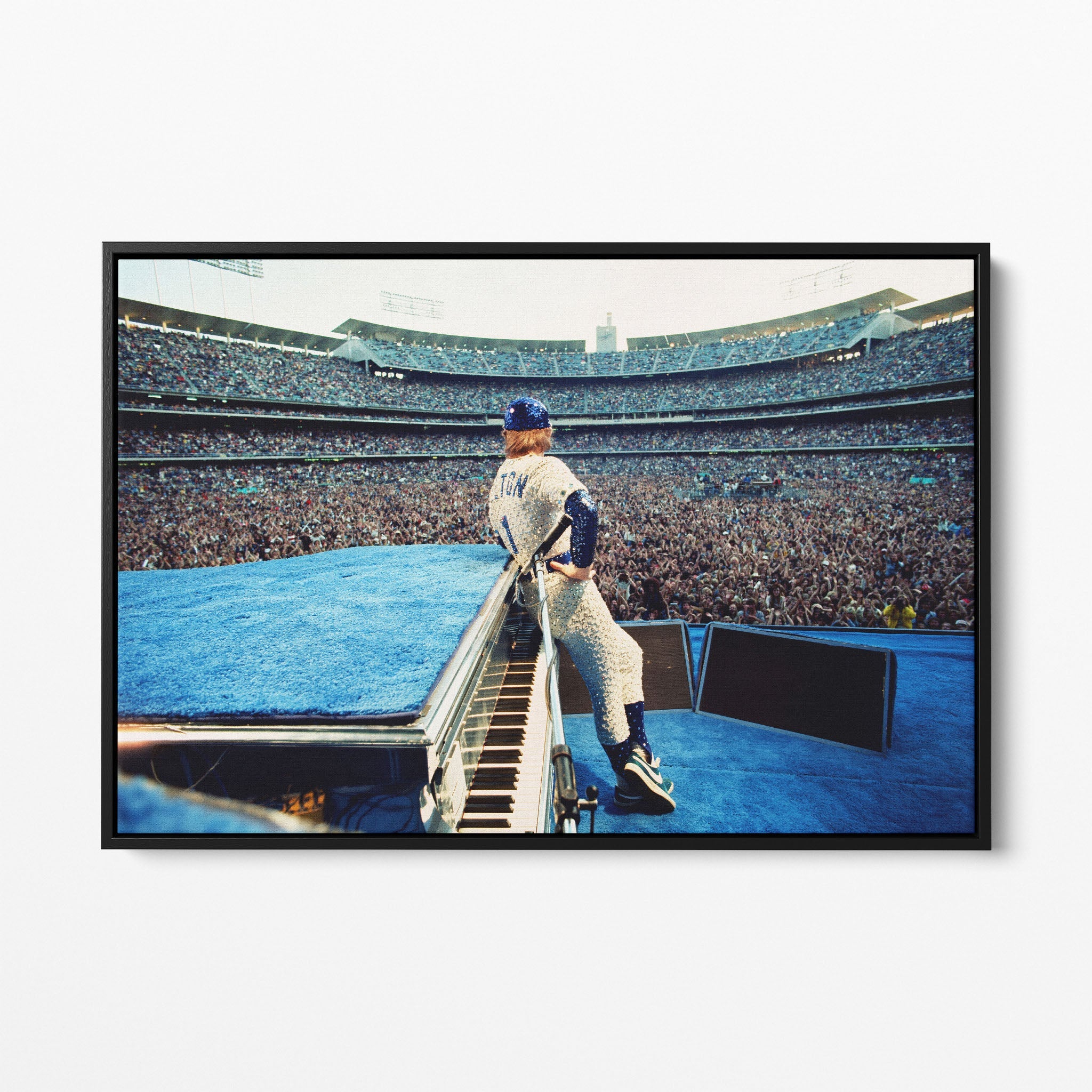 Front view of the Elton John 1975 colorized canvas in a sleek black floating frame.