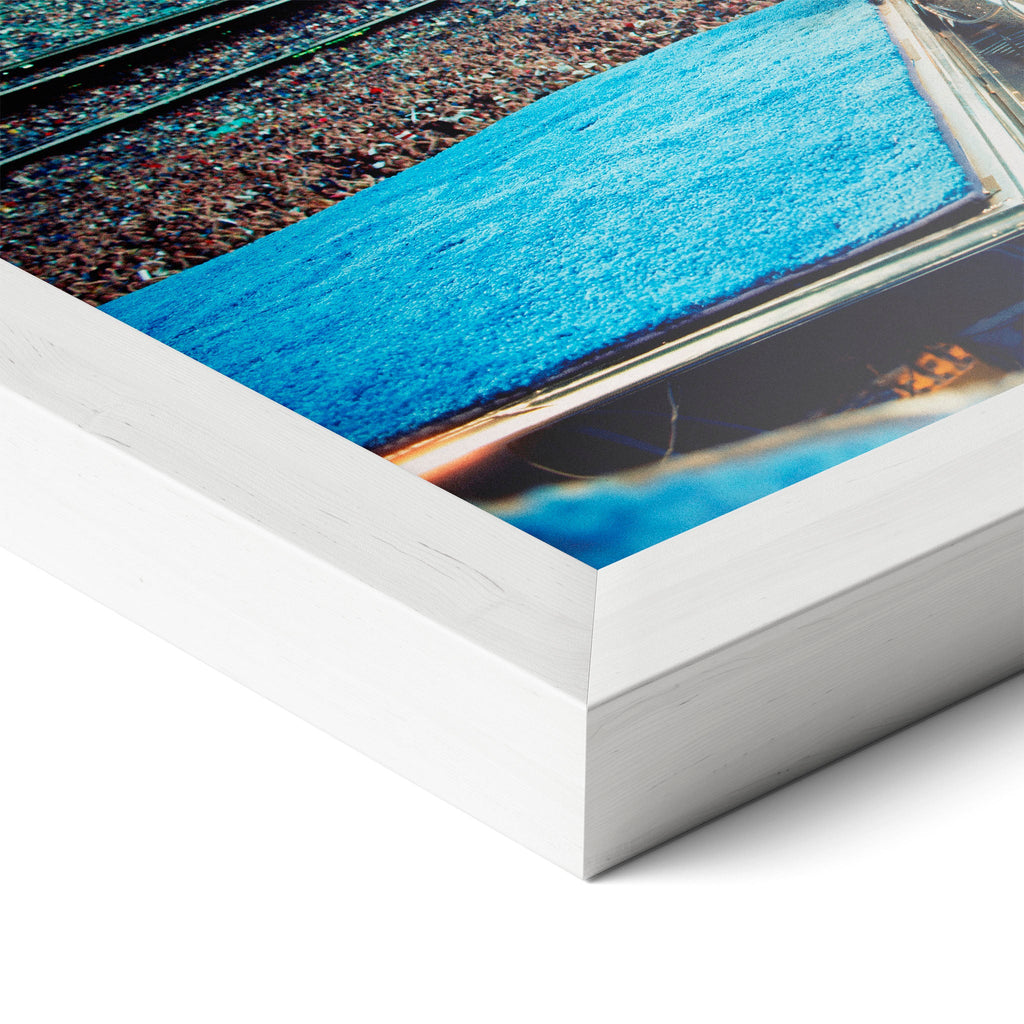 Corner close-up revealing the clean wood grain of the white framed Elton John 1975 colorized art print.