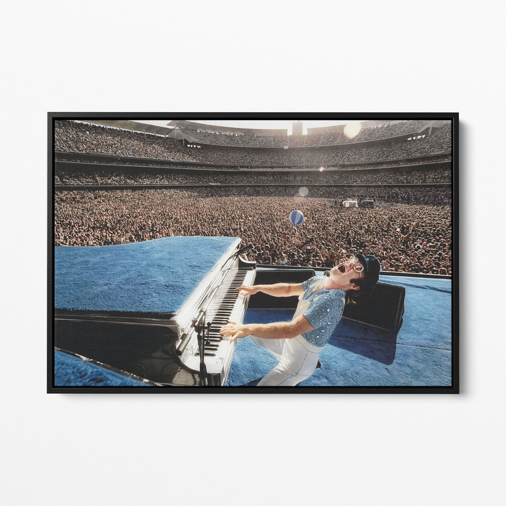 Front view of the Elton John 1975 colorized canvas in a sleek black floating frame.