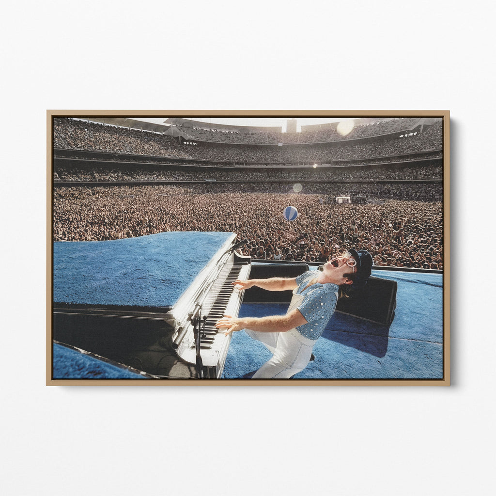 Front display of the Elton John 1975 colorized canvas in a premium natural wood floating frame.