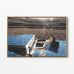 Front display of the Elton John 1975 colorized canvas in a premium natural wood floating frame.