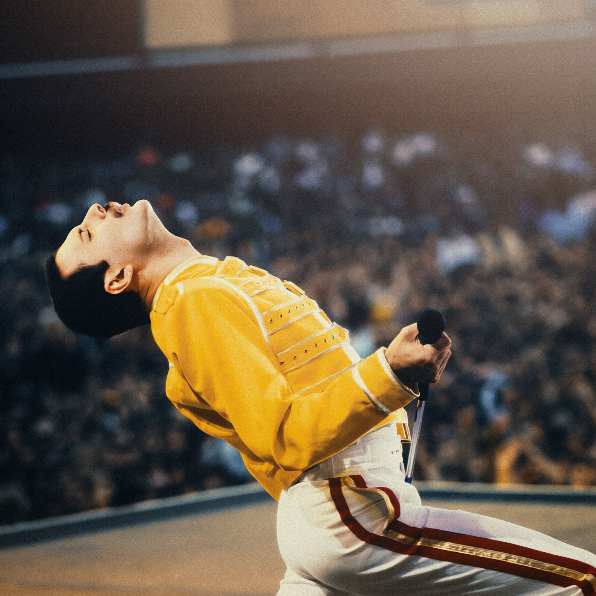 Zoomed detail of Freddie Mercury's yellow military-style jacket at Wembley 1986