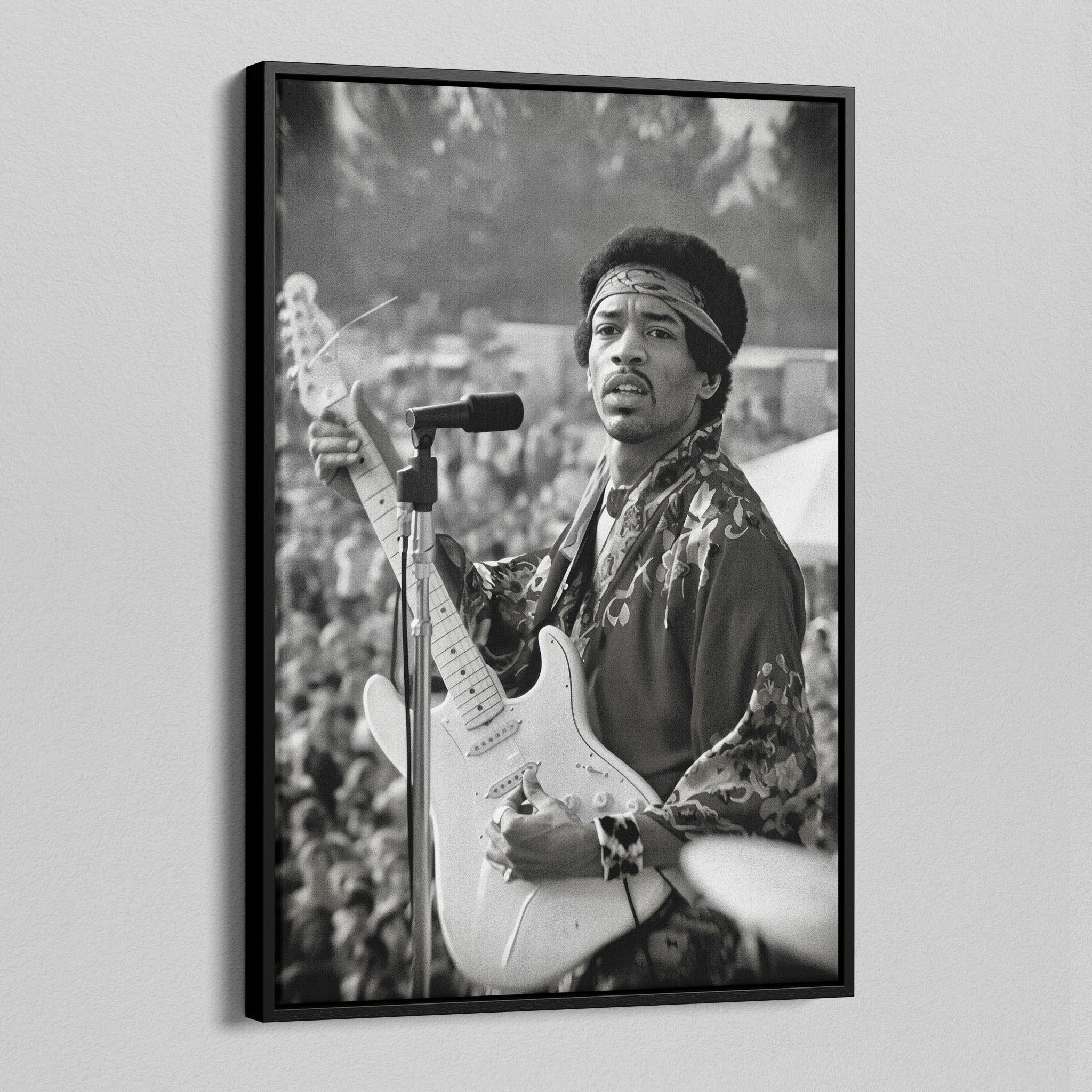 Angled view of the Jimi Hendrix black and white canvas in a black floating frame