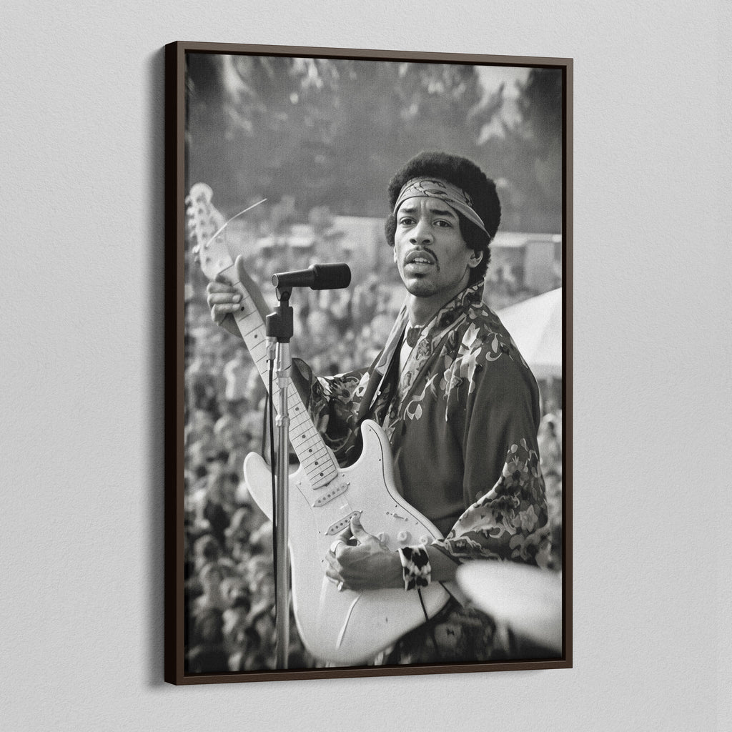 Angled view of the Jimi Hendrix black and white canvas in a dark walnut floating frame