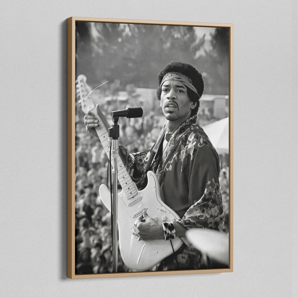 Angled view of the Jimi Hendrix black and white canvas in a natural oak floating frame