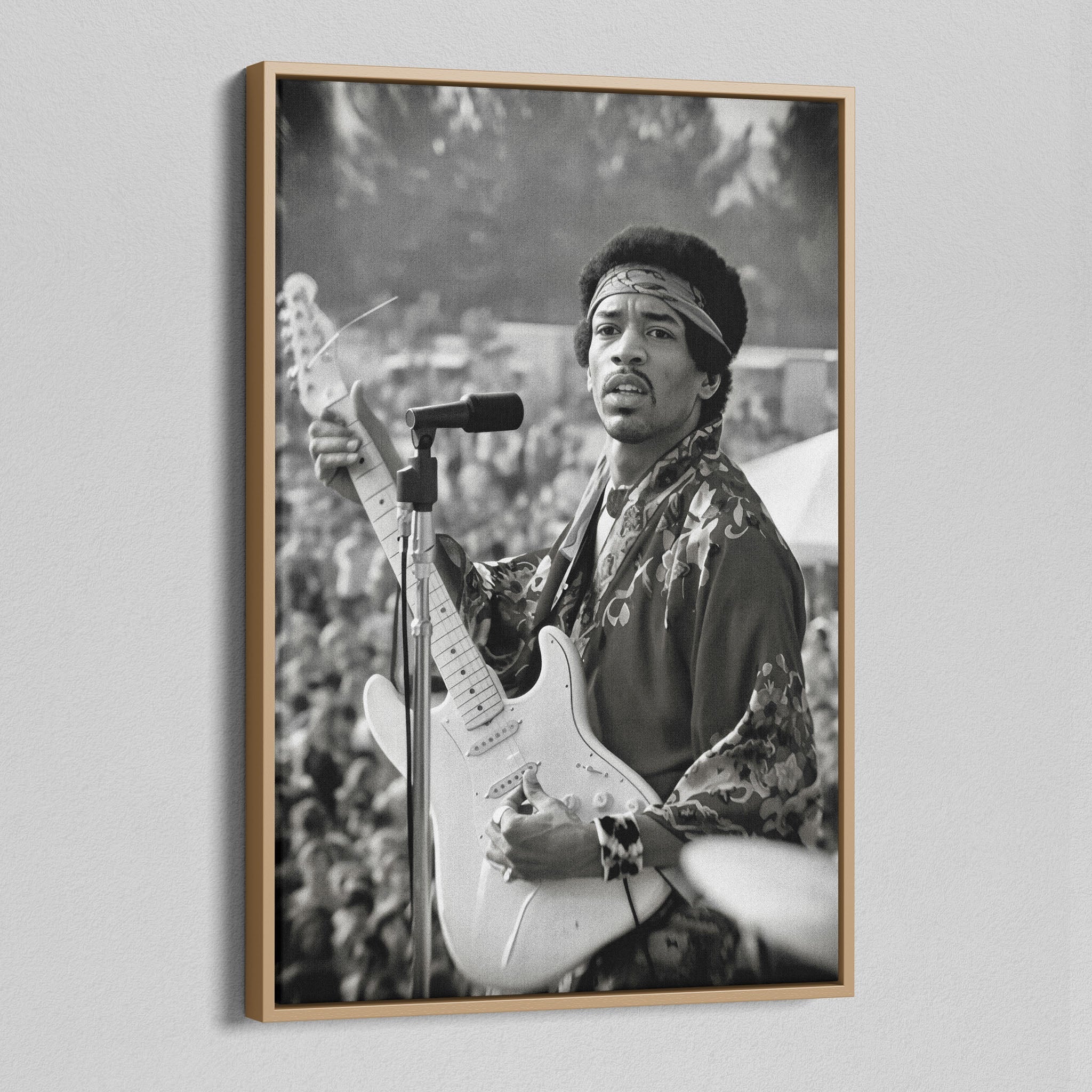 Angled view of the Jimi Hendrix black and white canvas in a natural oak floating frame