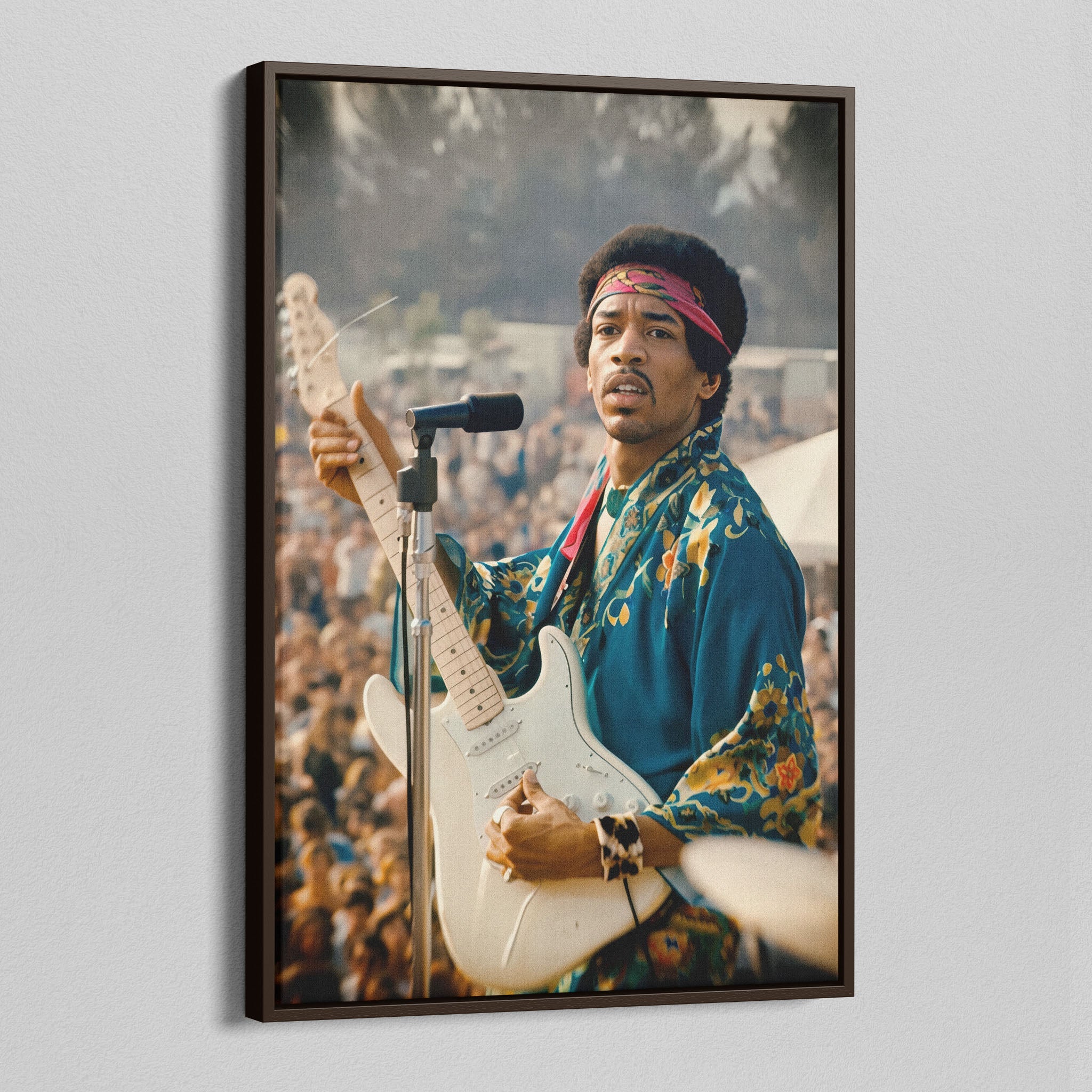 Angled view of the Jimi Hendrix colour canvas in a dark walnut floating frame