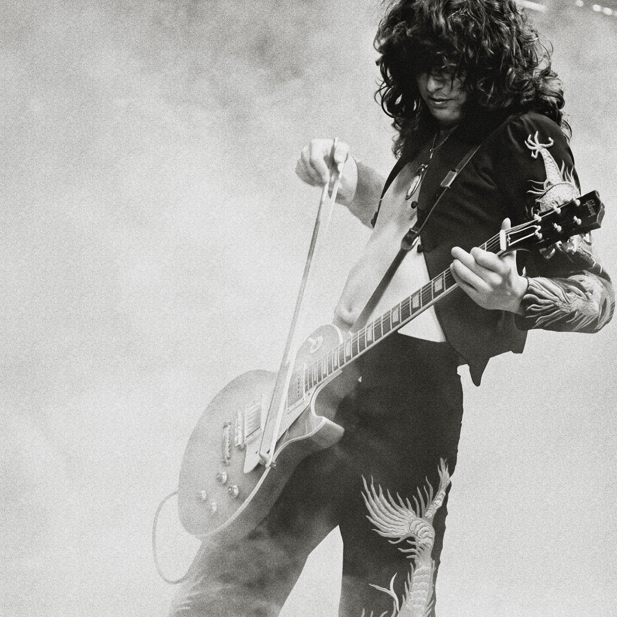 Zoomed detail of Jimmy Page's dragon suit and Les Paul in black and white