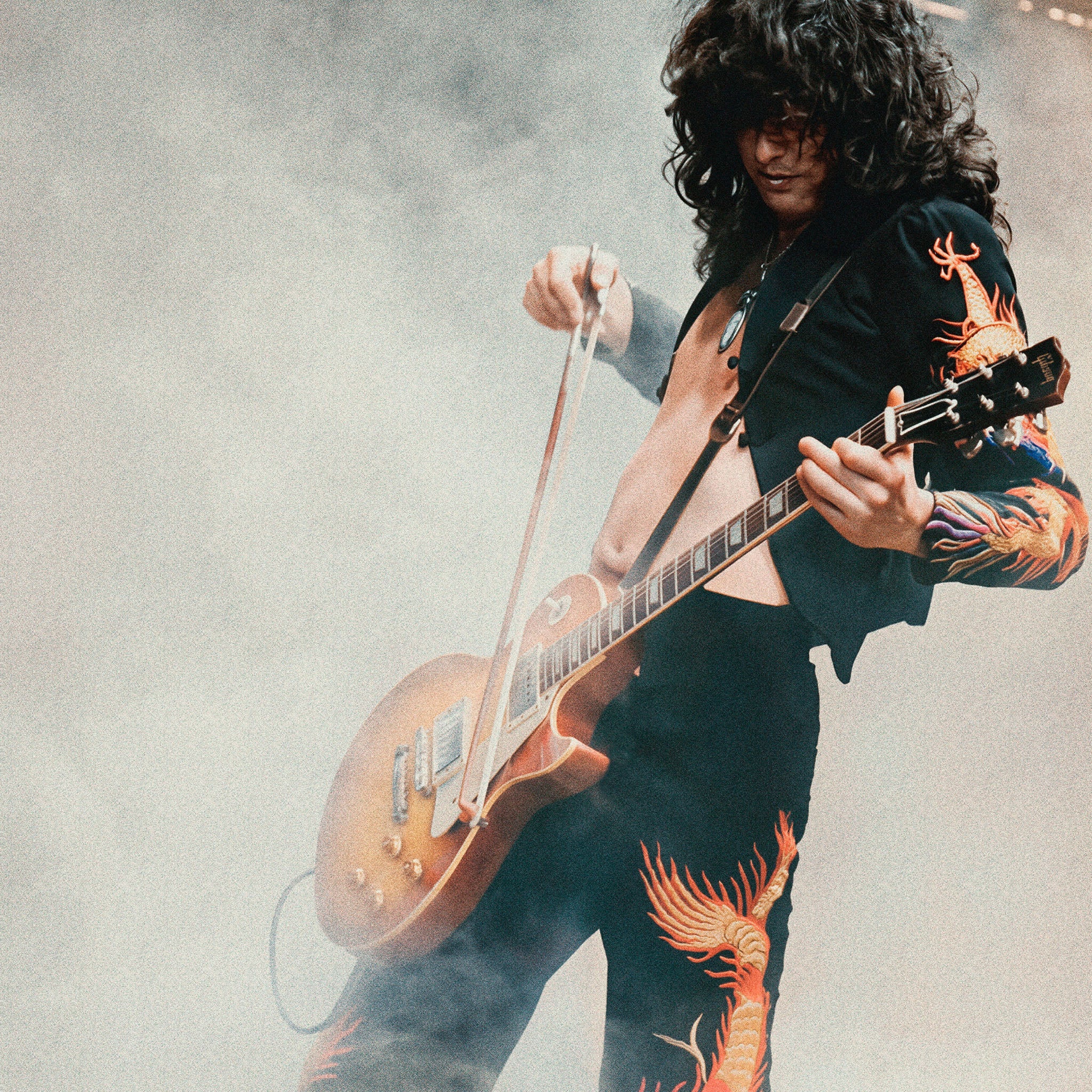 Zoomed detail of Jimmy Page's dragon suit and sunburst Les Paul in colour