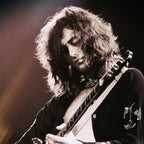 Zoomed detail of Jimmy Page playing his Danelectro slide guitar in 1975