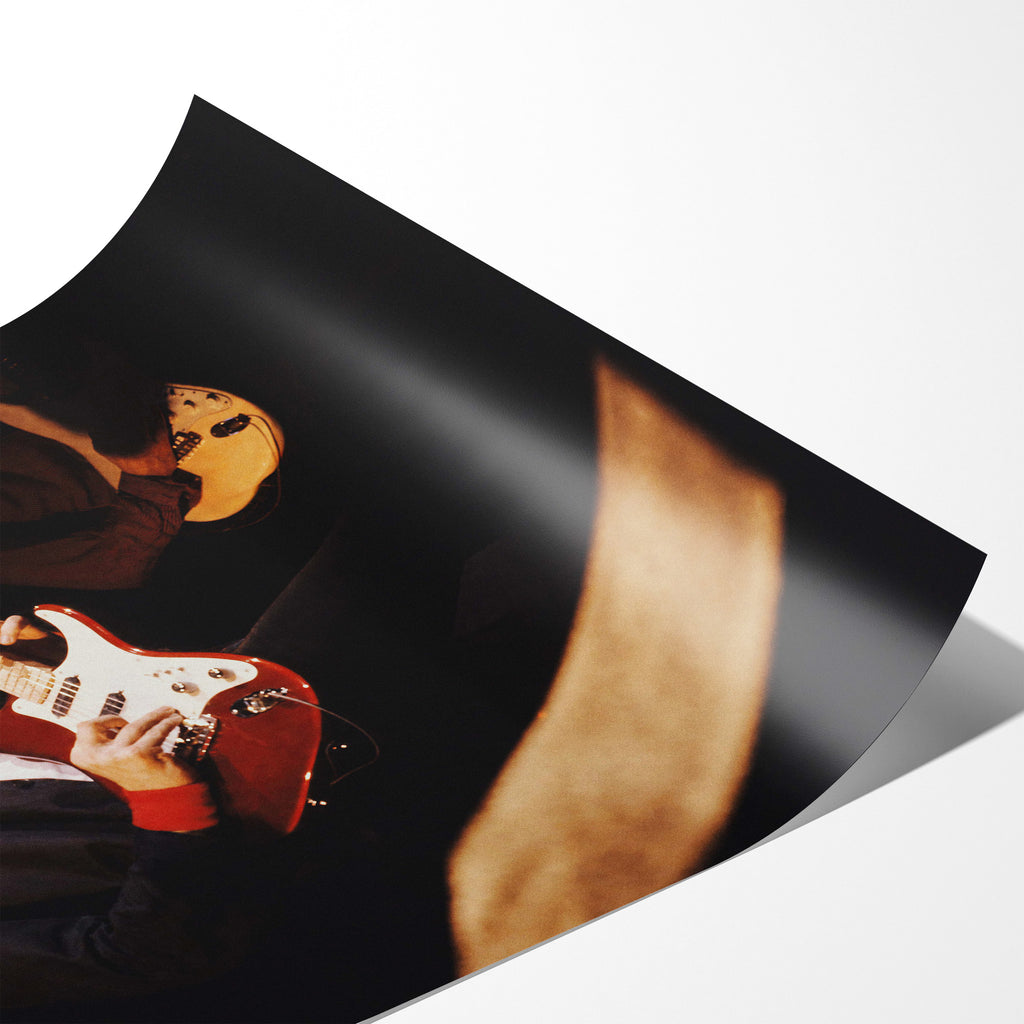 Angled close-up of the unframed Mark Knopfler color poster showing fine paper detail