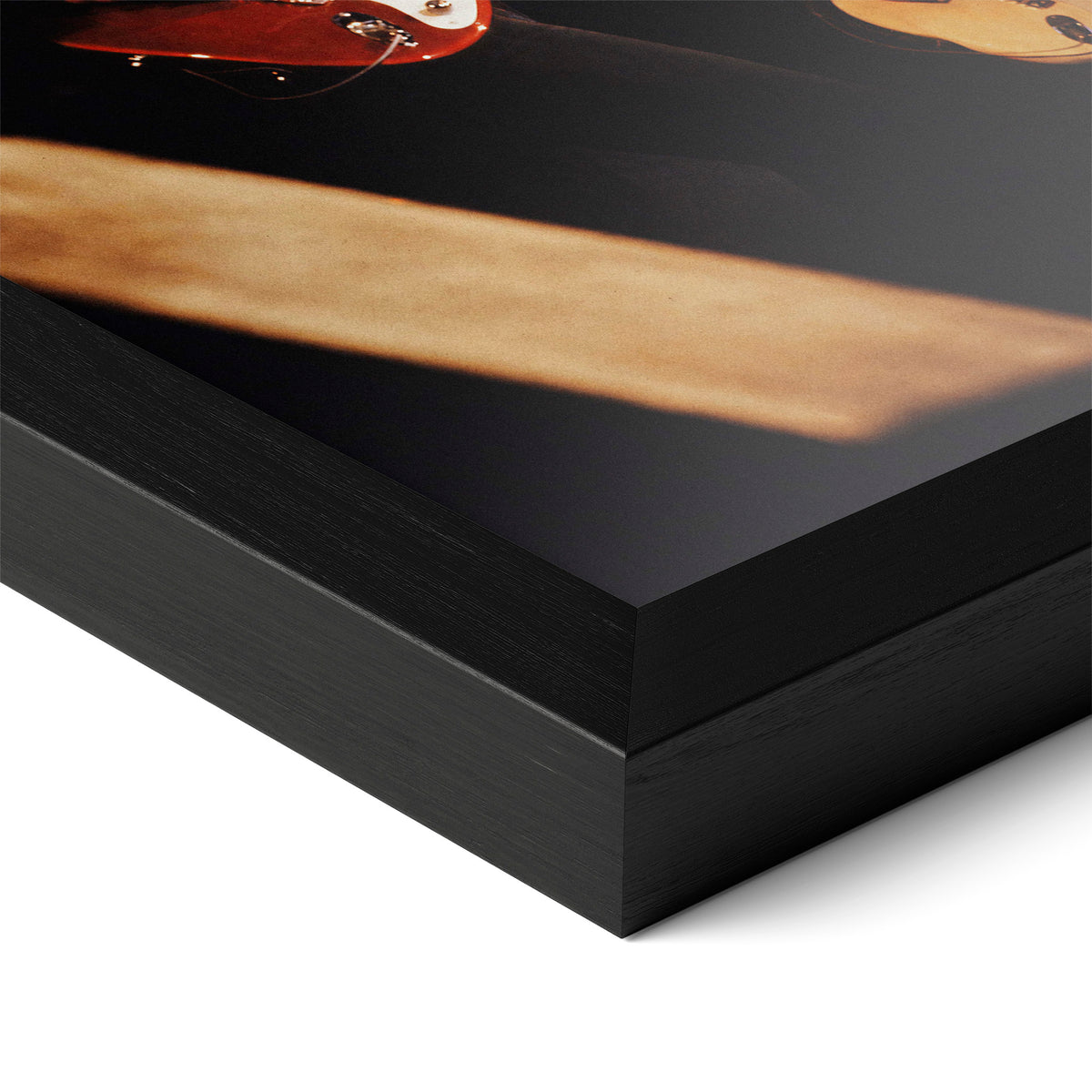 Close-up of the Mark Knopfler color poster in a classic black wood frame