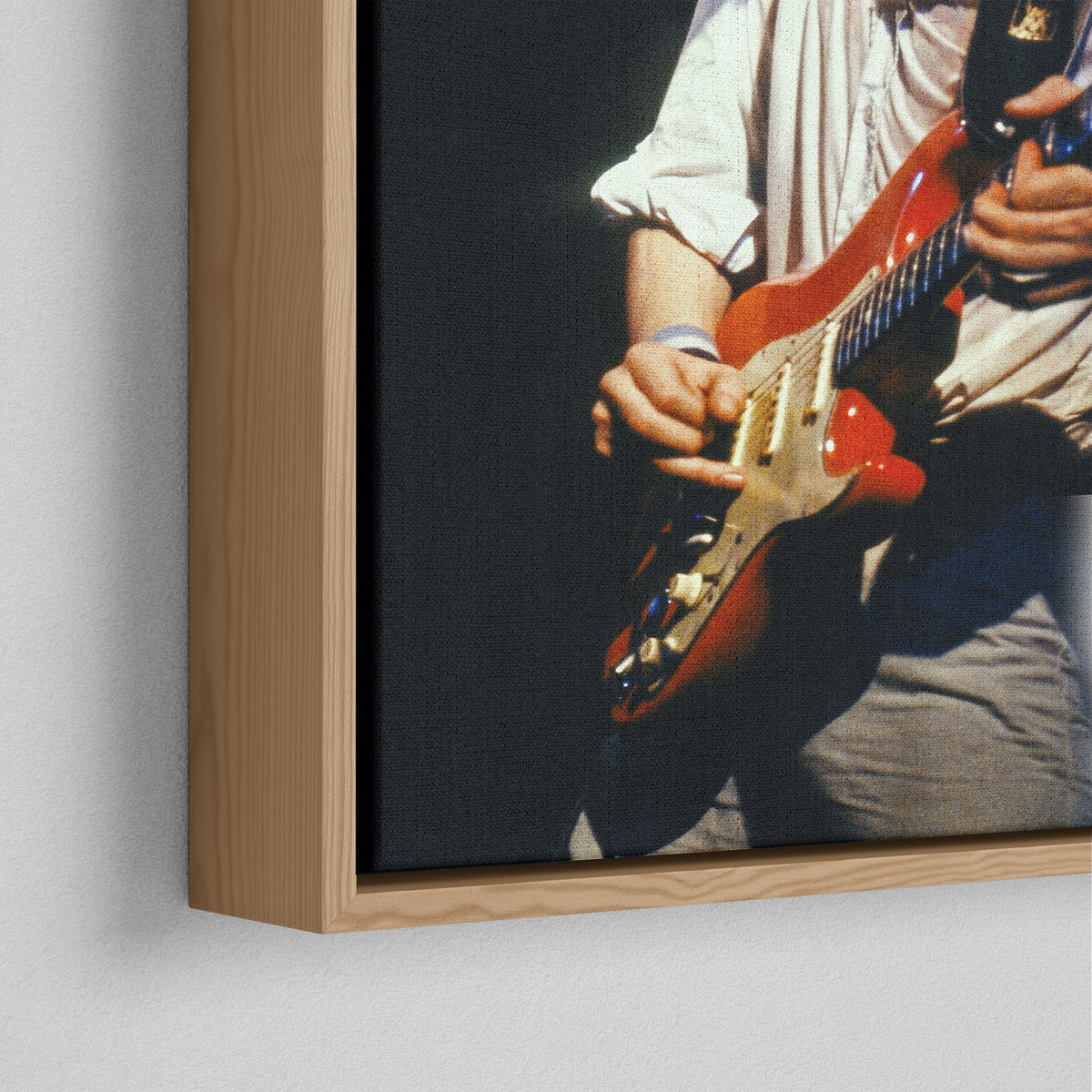 Corner close-up of the natural oak floating frame on the Mark Knopfler color canvas