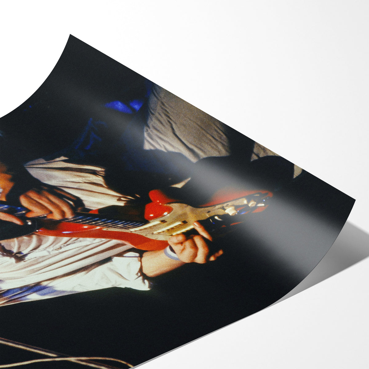 Angled close-up of the unframed Mark Knopfler color poster showing fine paper detail
