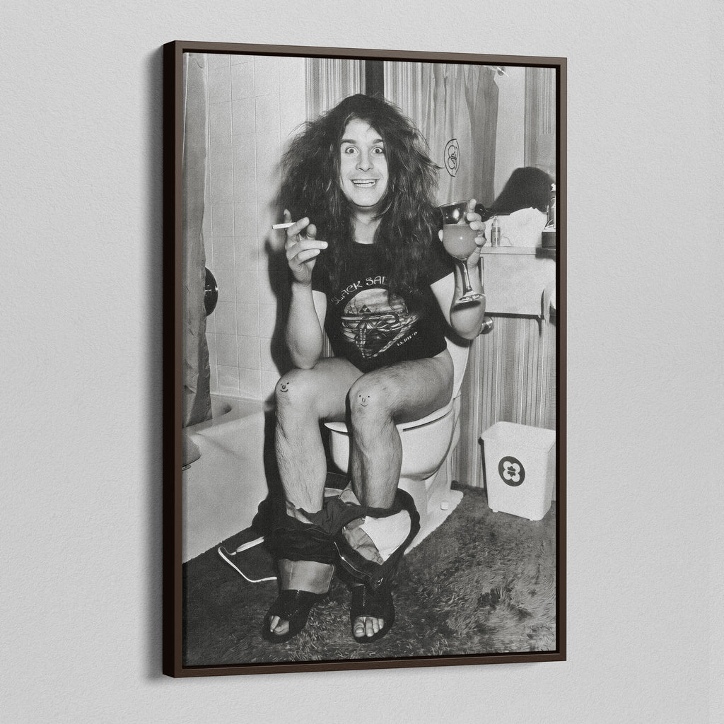 Angled view of the Ozzy Osbourne bathroom black and white canvas in a dark walnut floating frame