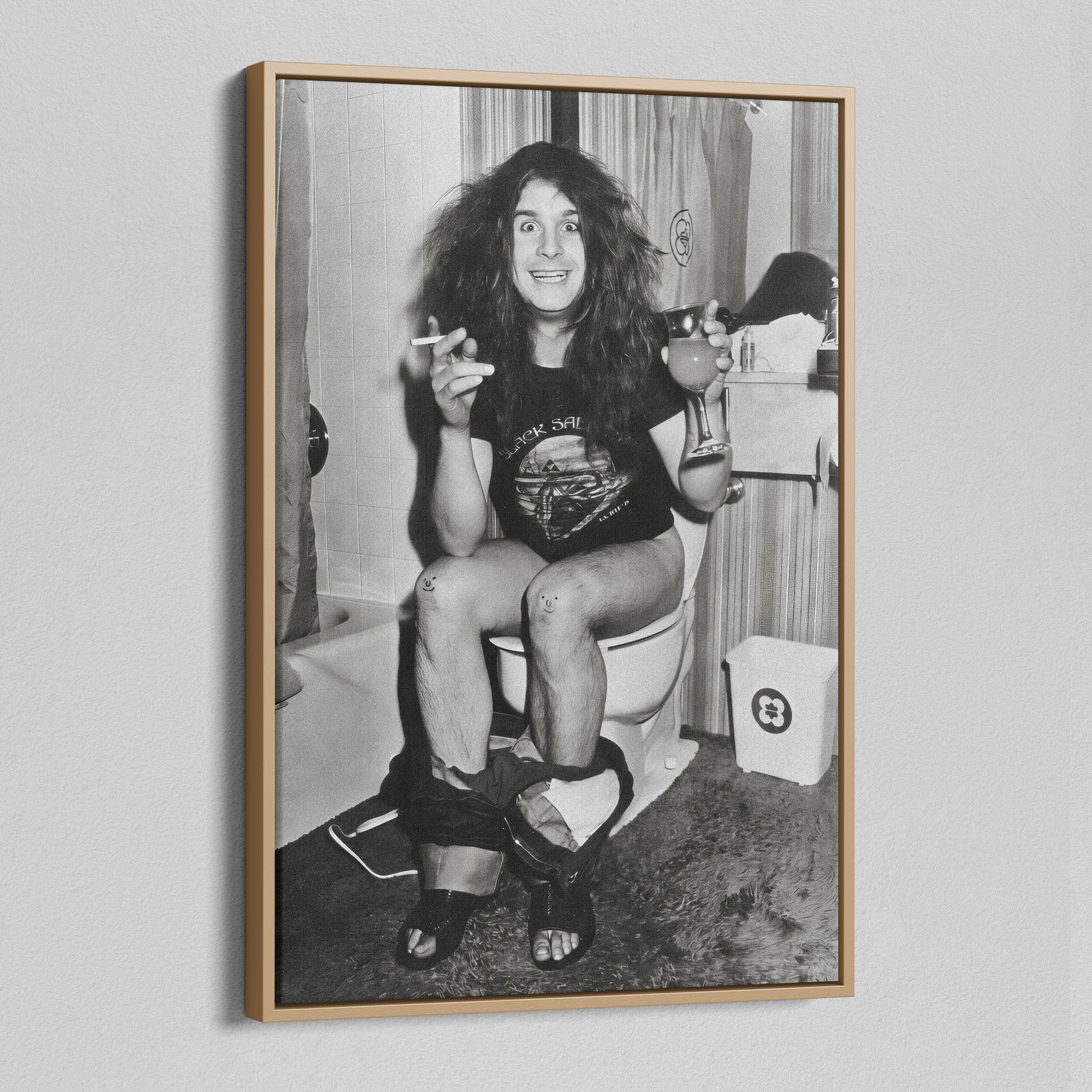 Angled view of the Ozzy Osbourne bathroom black and white canvas in a natural oak floating frame