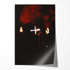 Unframed color print of Ozzy Osbourne raising a white cross between flaming torches and red smoke