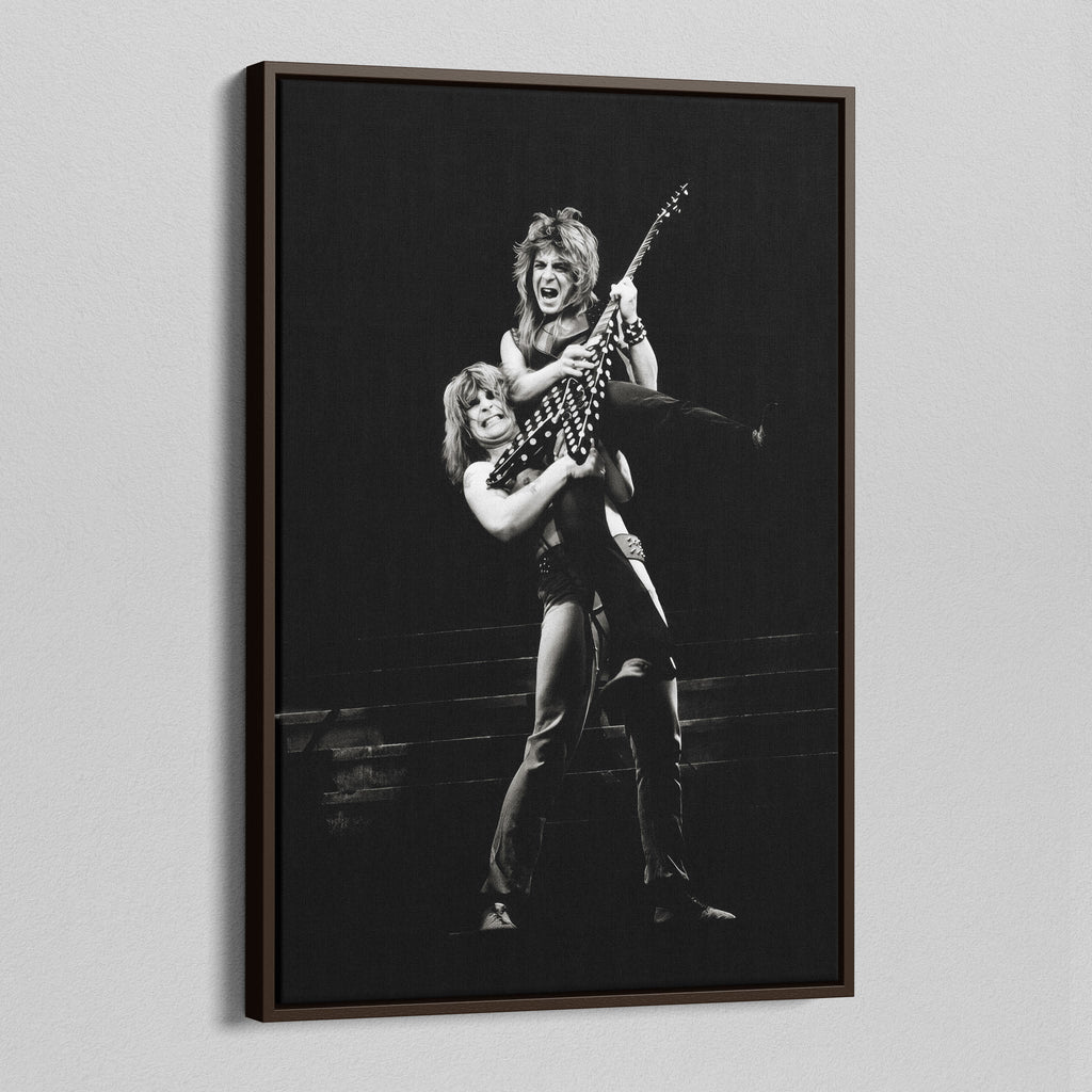 Angled view of the Ozzy and Randy Rhoads black and white canvas in a dark walnut floating frame