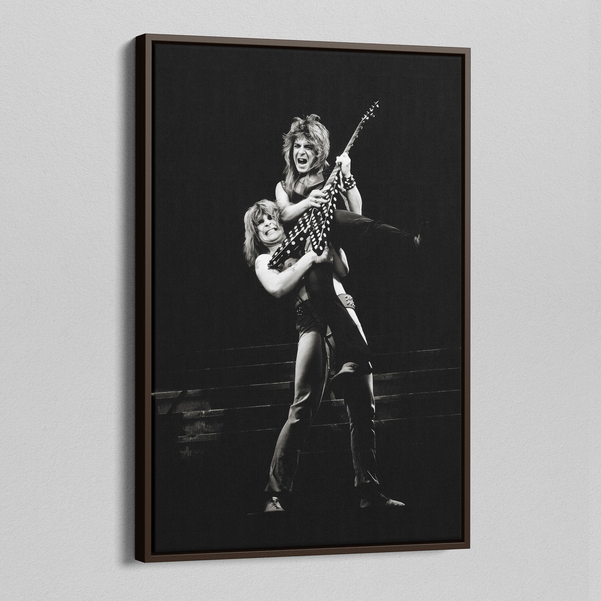 Angled view of the Ozzy and Randy Rhoads black and white canvas in a dark walnut floating frame