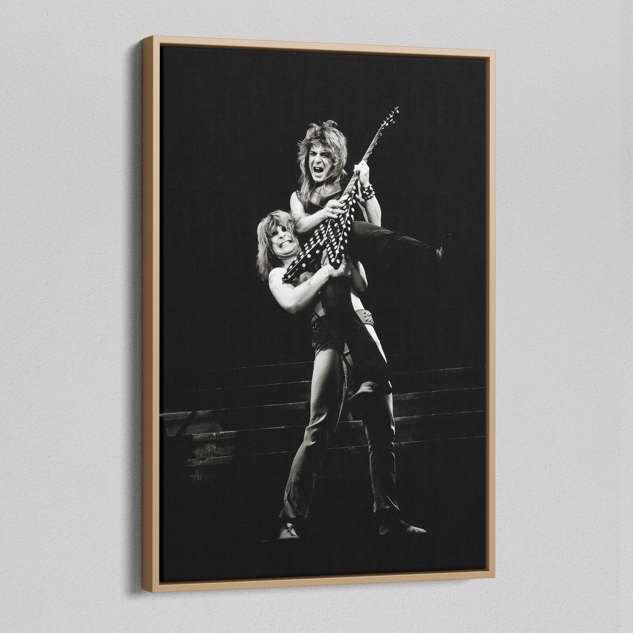 Angled view of the Ozzy and Randy Rhoads black and white canvas in a natural oak floating frame