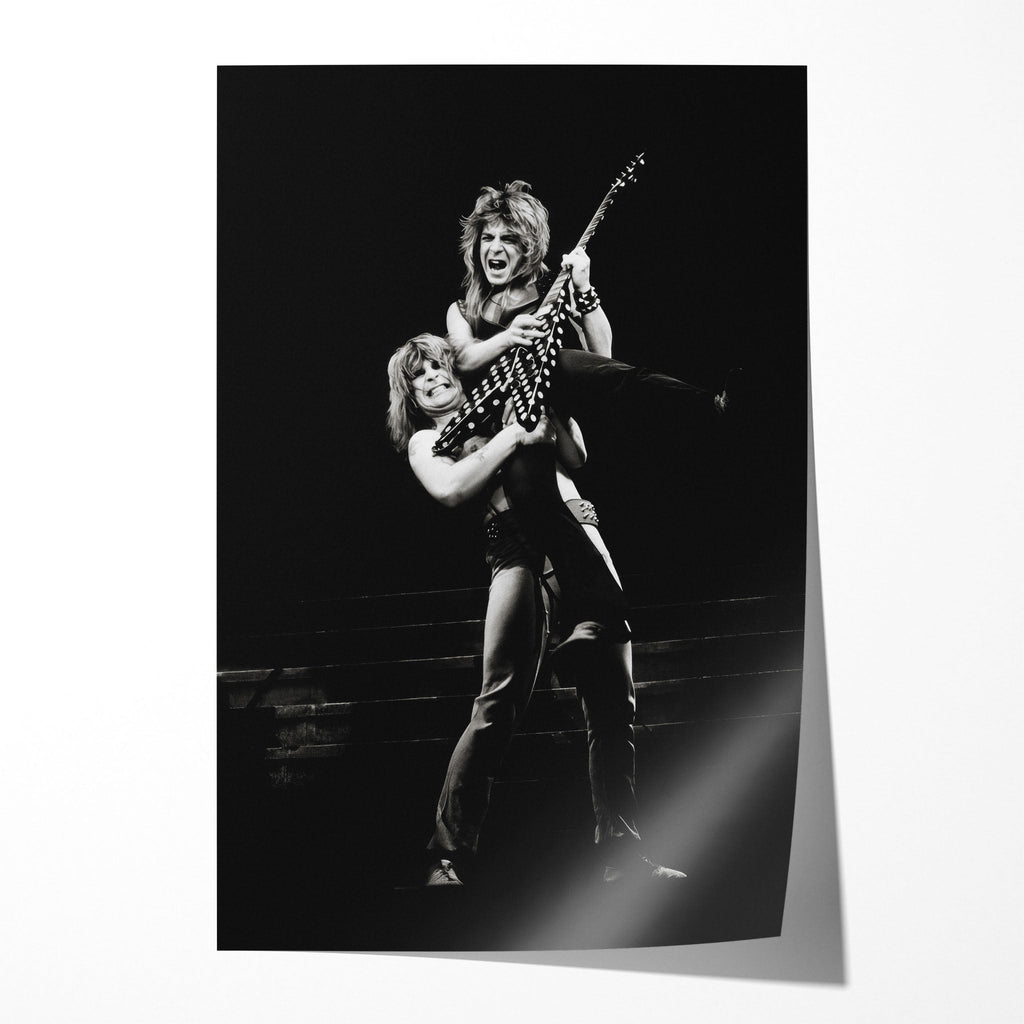 Unframed black and white print of Ozzy Osbourne lifting Randy Rhoads with his polka-dot Flying V, 1982