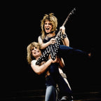 Zoomed detail of Randy Rhoads' polka-dot Flying V as Ozzy lifts him, 1982
