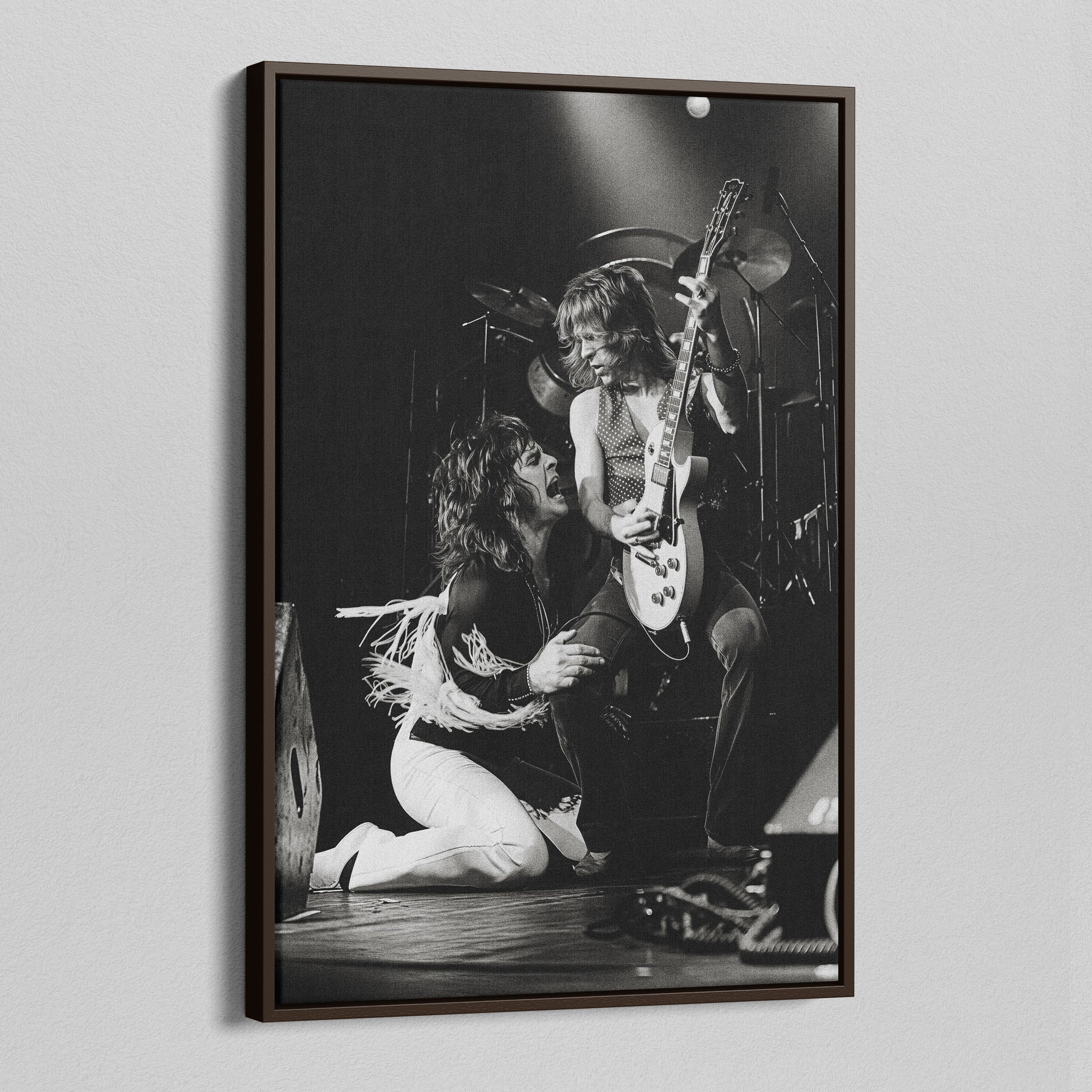 Angled view of the Ozzy and Randy Rhoads black and white canvas in a dark walnut floating frame