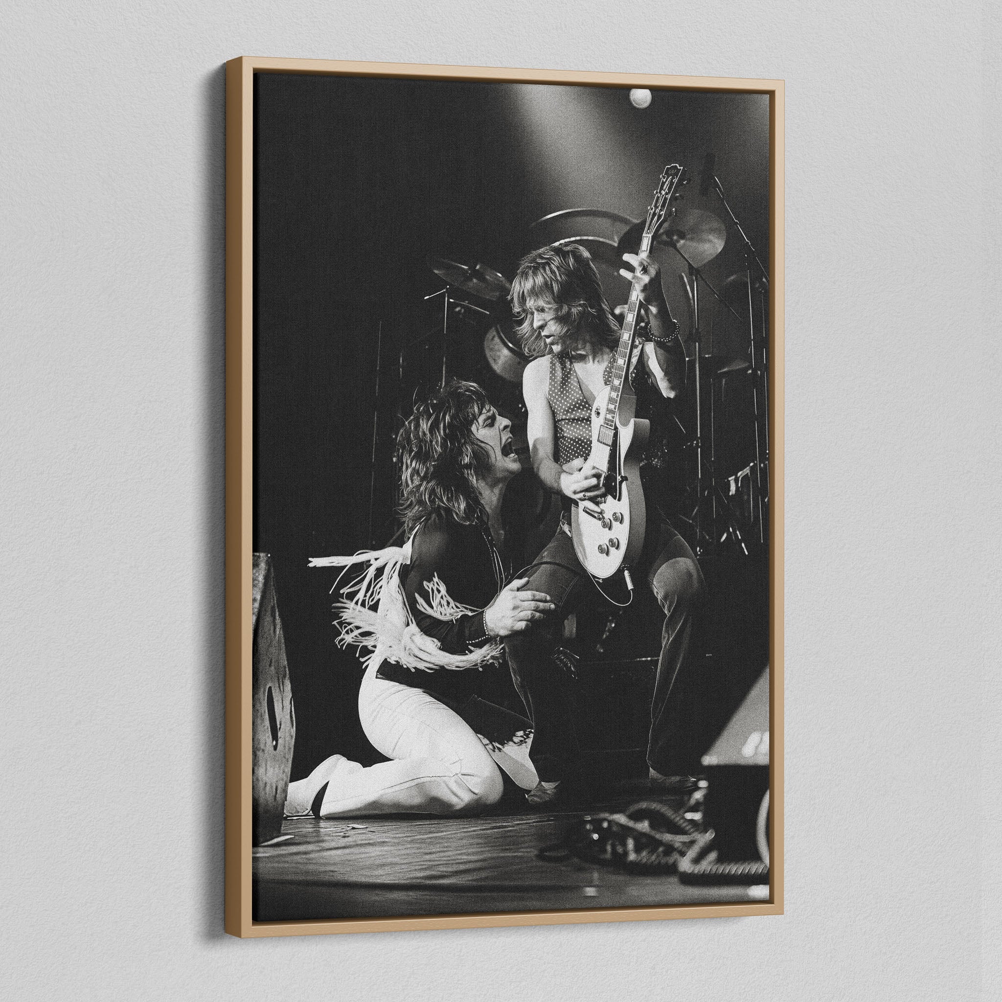 Angled view of the Ozzy and Randy Rhoads black and white canvas in a natural oak floating frame